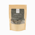 Kraft paper packaging of energy tea with visible tea leaves on a white background