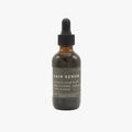 Hair serum bottle with dropper on a white background