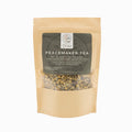 Bag of 'Peacemaker Tea' with visible tea leaves on a white background