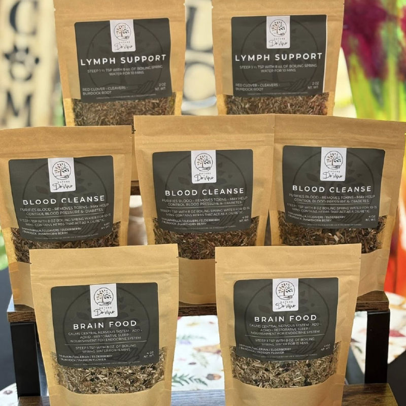 Assorted health teas packages labeled 'Lymph Support', 'Blood Cleanse', and 'Brain Food' on a blurred background.